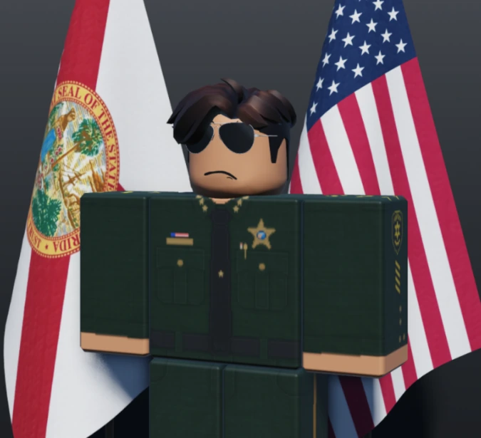 The Sheriff in Class A uniform in front of the Florida and United States flags